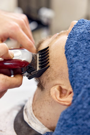 male hands of barber with hair clipperの写真素材