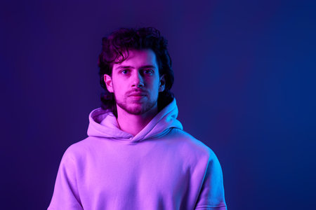handsome bearded man in sweatshirt on blue background.