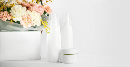 cosmetic beauty product bottle mockup and flowerの写真素材