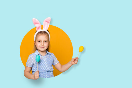 cute little girl with Easter bunny ears holding colorful eggs