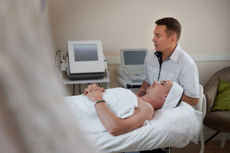 handsome man on RF lifting procedure in medicine clinicの写真素材