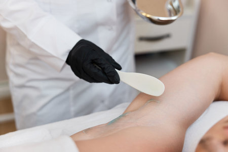 young man undergoes procedure of arm pit laser epilationの写真素材