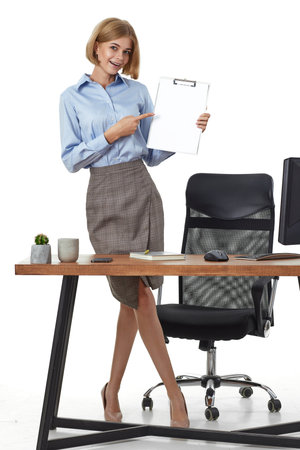 businesswoman in formal wear with clipboard in officeの写真素材