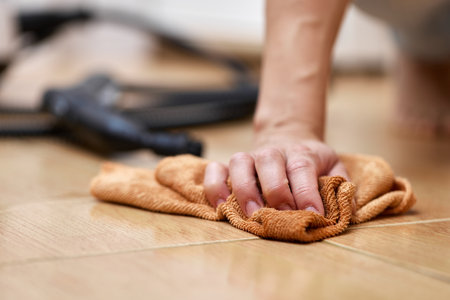 hand with a rag washing the tiled floor, home cleaningの写真素材