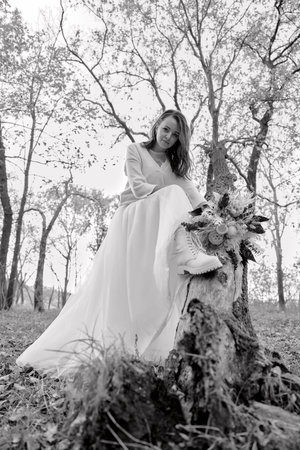 beautiful bride holding wedding autumn bouquet in nature. black and whiteの写真素材