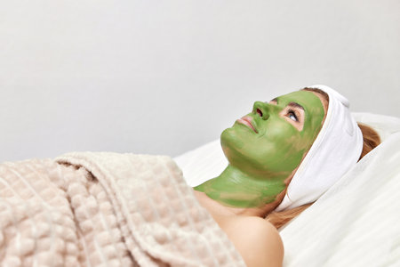 beautiful woman with green alginate mask on faceの写真素材