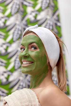 beautiful woman with green alginate mask on faceの写真素材