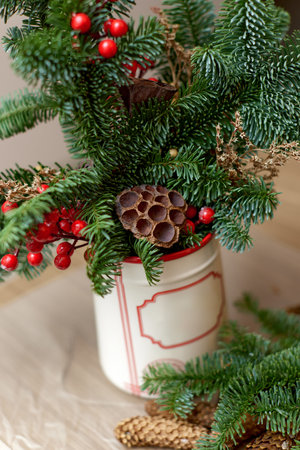 Homemade christmas decorations on table. Christmas bouquet in vaseの写真素材