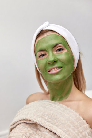 beautiful woman with green alginate mask on faceの写真素材