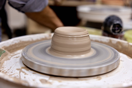 male hands making ceramic cup on pottery wheel, Close-upの写真素材