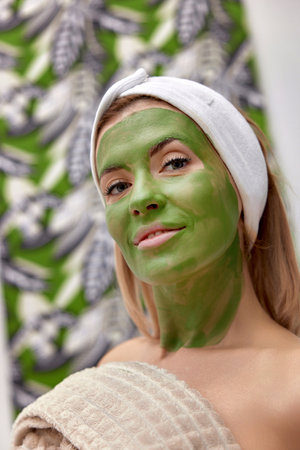 beautiful woman with green alginate mask on faceの写真素材