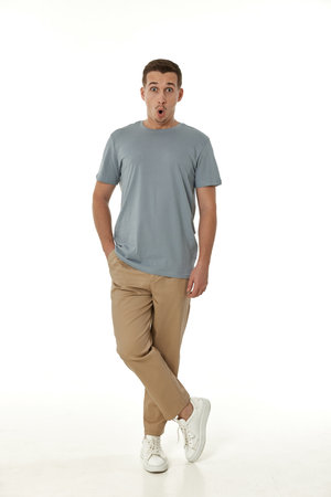 surprised guy looking at camera on white studio backgroundの写真素材