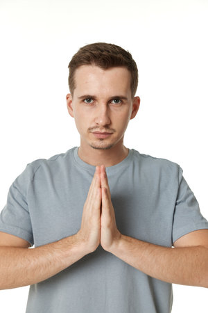 Praying, prayer man with hands in meditation on white background