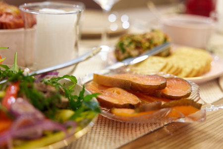 festive table with red fish. banquet table with appetizers.の写真素材