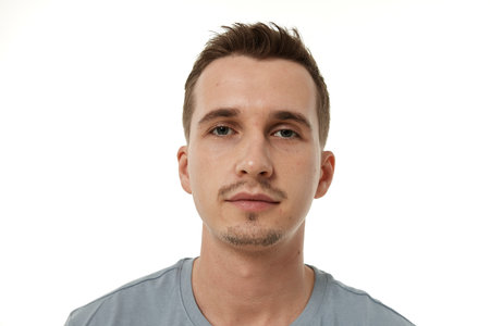portrait of young calm man on white backgroundの写真素材
