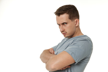 Portrait of offended frustrated young man on white background. sadnessの写真素材