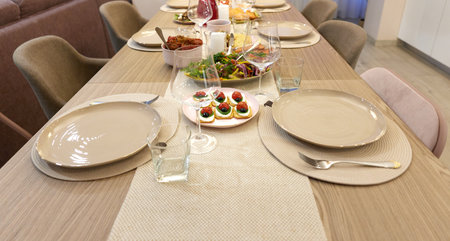 Table served for festive dinner in living roomの写真素材