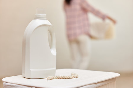washing gel or laundry detergent on white laundry basket. Mock up, copy space.の写真素材