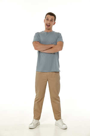 surprised guy looking at camera on white studio backgroundの写真素材