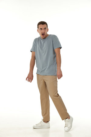 surprised guy looking at camera on white studio backgroundの写真素材