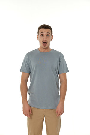 surprised guy looking at camera on white studio backgroundの写真素材