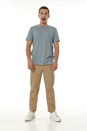 surprised guy looking at camera on white studio backgroundの写真素材