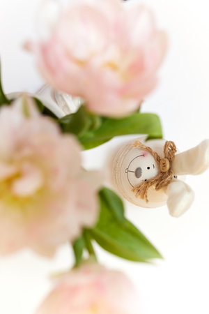 bouquet of tulips and Easter bunny on white table. copy spaceの写真素材