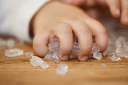 close-up of little child girl hand holds small cubes of soap for hand-made soap, art workshops for children.の写真素材
