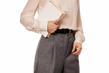 woman in white shirt holding book isolated on white backgroundの写真素材