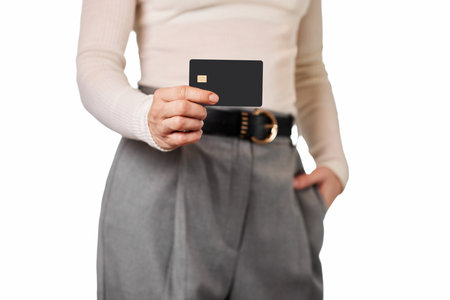 female hand holding black premium credit bank card on white background. credit card for online paymentの写真素材
