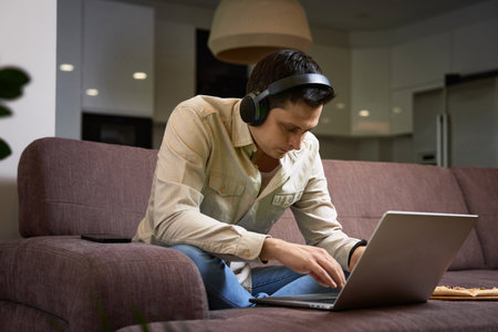 Freelancer man working with laptop at homeの写真素材