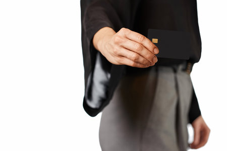 Caucasian woman in formal clothes holding black premium credit bank card on white background. Money financeの写真素材