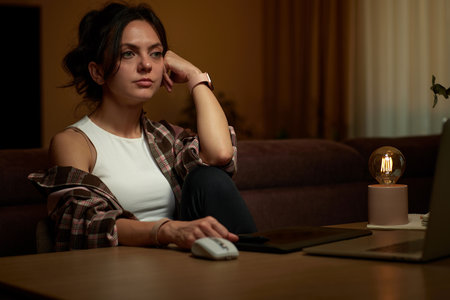 beautiful graphic designer woman working at home office remotely using digital graphic tablet and laptopの写真素材