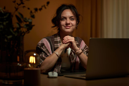 beautiful graphic designer woman working at home office remotely using digital graphic tablet and laptopの写真素材