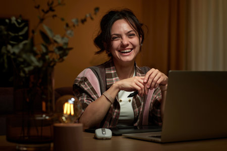 beautiful professional female retoucher woman working at home workspace using digital graphic tablet and laptopの写真素材