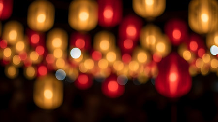 Blurred glowing lanterns in warm orange and red colors create a festive night atmosphere.の素材