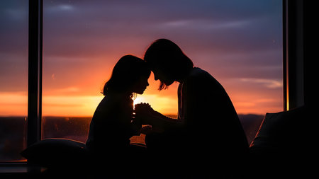 silhouetted couple enjoying romantic closeness near window with colorful sunset sky in background indoorsの素材
