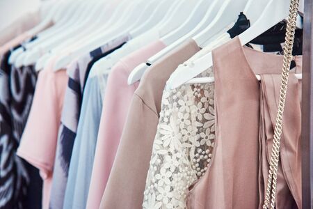 Details of bright beautiful pastel tones dress collection in show roomの写真素材