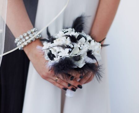 Very uncommon beautiful stylish concept bridal bouquet with black feathersの写真素材
