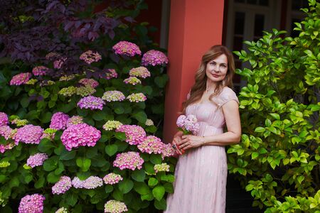 Single woman in bridal dress dreaming of marriage