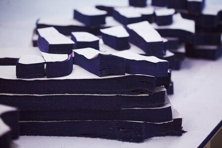 Cut ready for sewing details of future cloths on cloth factory after cloth cutting machineの写真素材