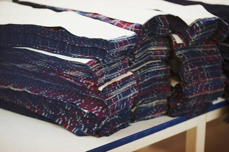 Cut ready for sewing details of future cloths on cloth factory after cloth cutting machine
