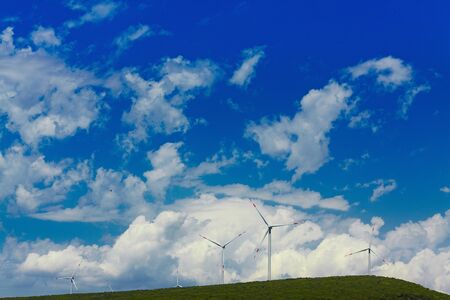 Wind mill turbines on beautiful sky backgroundの写真素材