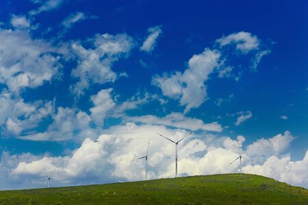 Wind mill turbines on beautiful sky backgroundの写真素材
