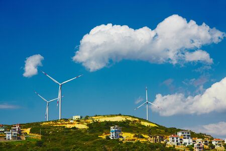 Wind mill turbines on beautiful sky backgroundの写真素材