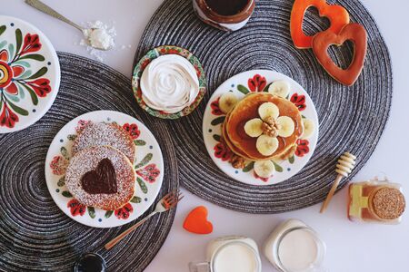 Breakfast pancakes served with honey and fruits
