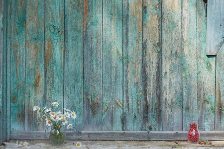 Charming still life with copy space strawberries and daisies on wood background