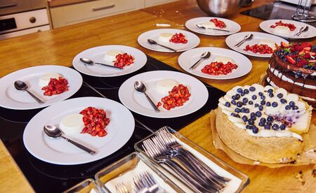 Blueberry cake and fruit chocolate cakes are being served in restaurantの写真素材