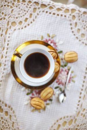 Traditional russian festive cookies "nuts" served with cofee in golden cupの写真素材
