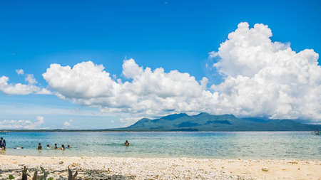 An empty beach with golden sand and blue skies